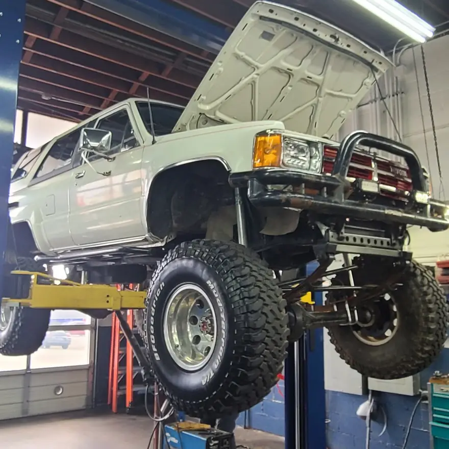 An older Toyota 4x4 on the lift at KC Martin Automotive in Lynnwood