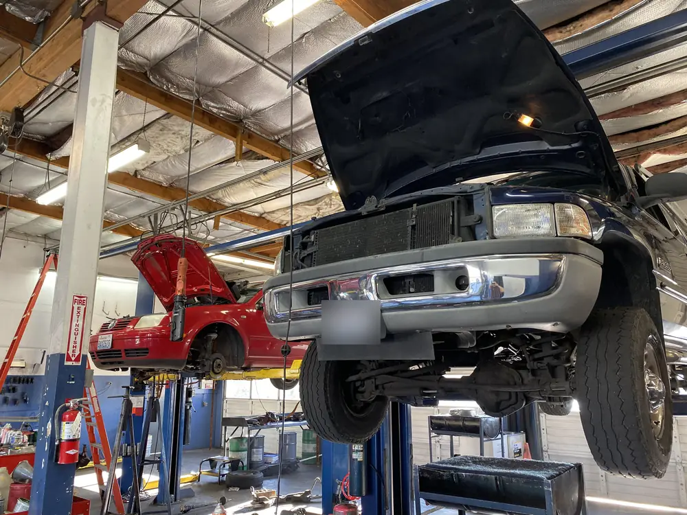 A Ram 2500 pickup on the lift with its hood open